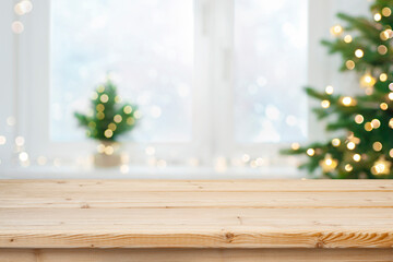 Wall Mural - blurred christmas lights holiday interior background with wooden table for products montage