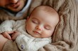 © FrameFlow - Little baby boy sleeping in his father's arms, Generative AI