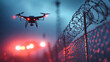 © Anoo - Drone patrols barbed wire fence while police lights illuminate the area in a futuristic border security operation at dusk