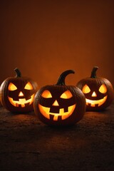 Three illuminated jack-o'-lanterns on a dark surface