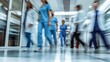 © VINA - Blurred motion of medical staff walking in a hospital corridor.