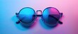 © StockKing - Blue tinted sunglasses placed against a backdrop of blue and pink hues with a designated area for adding text ideal for a creative copy space image