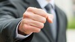© admin_design - Confident businessman in suit makes a pointing gesture with determined expression