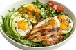 © venusvi - Eggs in a paleo meal with avocado, grilled chicken, and leafy greens on solid white background