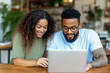 © Pompozzi - Focused Couple Collaborating on Laptop