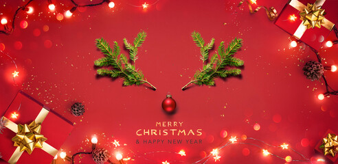 Wall Mural - christmas red background - deer with green fir branches elements and gift boxes - festive xmas flat 
