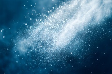 Wall Mural - white powder splashing and exploding on blue background creating bokeh and particles for wallpaper a