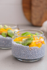 Canvas Print - Chia pudding with mango and kiwi in jar. Vegan breakfast concept.