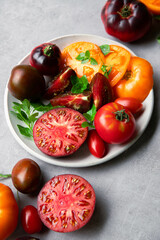 High-resolution image of fresh, juicy red tomatoes with water droplets on a clean background. This photo is perfect for promoting organic produce, healthy food, or farm-to-table concepts. 