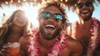 © Maximages  - A happy group of friends wearing floral leis, casually dressed, are laughing and enjoying each other's company with drinks in hand, creating cheerful memories together.