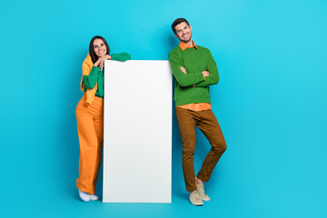 Wall Mural - Photo of two people bloggers advertise electronics gadget mobile phone board isolated on blue color background