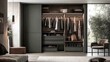 © Intach - Open sliding door wardrobe with clothes and shoes arranged symmetrically, next to a cozy bedroom setup.