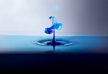Fototapete - A single blue drop of liquid splashes into water, creating an intricate, swirling pattern.