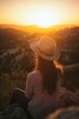 © StockUp - A solitary figure in a hat contemplates the serene sunset, embracing quietude and reflection in a picturesque landscape.