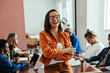 © (JLco) Julia Amaral - Stylish businesswoman in colorful boardroom engaged in creative teamwork