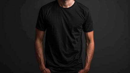 Wall Mural - A man in a black t-shirt with tattoos on his left hand and arm looks at the camera in a casual, relaxed manner, with hands in pockets.