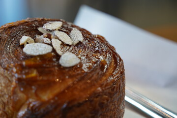 Close-up image of a fresh baked croissant with almonds