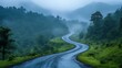 © Purnomo adi - A winding road through lush green mountains shrouded in mist, creating a sense of mystery and adventure.
