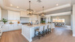© Vian - Contemporary kitchen with white cabinets, pendant lighting, and a touch of greenery