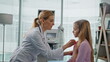 © stockbusters - Professional practitioner talking child in clinic closeup. Sick girl visiting