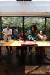 © Caia Image - Group of people doing arts and crafts