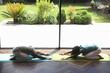 © Caia Image - Man and woman practice yoga