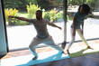 © Caia Image - Woman and man with Down syndrome practice yoga