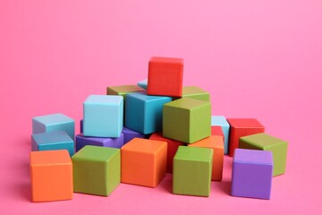 Wall Mural - Many wooden colorful cubes on pink background