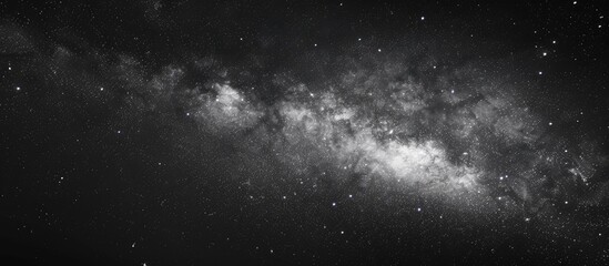 Wall Mural - a striking image showcasing the milky way galaxy against a starry night sky in black and white with 