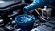 © Andre Jovi - Blue Fluid Being Poured into a Car Engine Reservoir