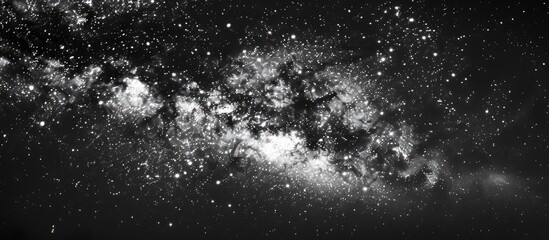 Wall Mural - a striking image showcasing the milky way galaxy against a starry night sky in black and white with 