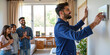 © Reubens Stock Photos - Professional Indian Technician Setting Up Smart Home Appliance as Family Watches In Anticipation