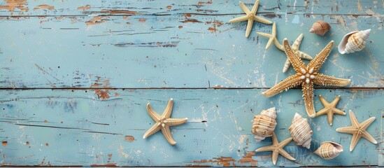 Wall Mural - A maritime theme featuring starfish and seashells on a vintage blue wooden backdrop with copy space image available