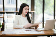 © Witoon - Asian businesswoman working with laptop in office