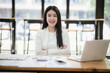 © Witoon - Asian businesswoman working with laptop in office