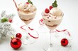 © Vii - Two glasses of ice cream decorated for Christmas with festive ornaments and lights