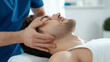 © alphaonetwo - Close up of hand Therapist providing a neck and hand massage to a patient