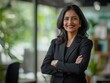 © foggycloud - Confident mid-aged indian businesswoman smiling with folded arms