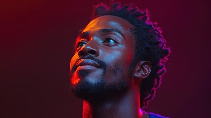 Confident young man with unique hairstyle under colorful lighting