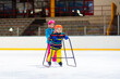 © famveldman - Child skating on indoor ice rink. Kids skate.
