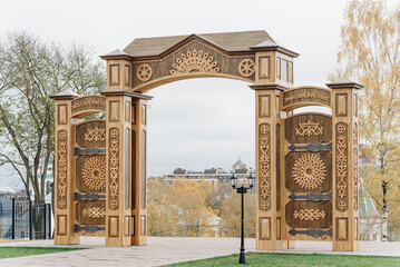 Russian North Gates, large wooden gates with decorative ornament, art-object of Vyatka wooden architecture using wood carving, area fof tourists, located in Kirov, Russia