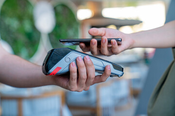 A person is using a credit card reader to pay for something