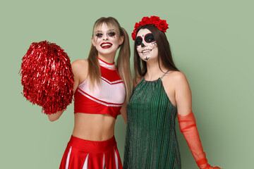 Wall Mural - Female friends dressed for Halloween on green background