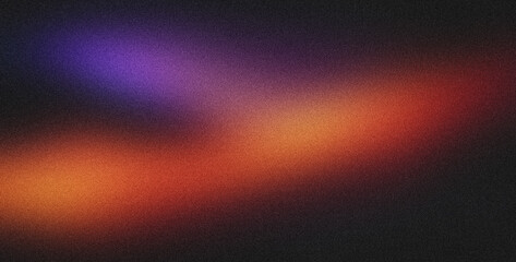 Grainy gradient is blending orange, purple and black in this abstract background image