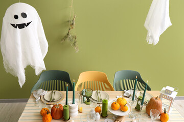 Sticker - Festive table setting with burning candles, pumpkins and ghost for Halloween party at home