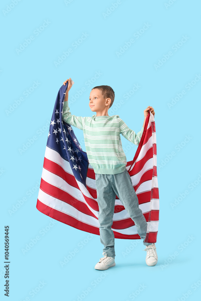 Little boy with USA flag on blue background. Veterans Day celebration