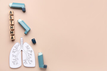 Wall Mural - Inhalers, paper lungs and wooden cubes with text ASTHMA on beige background