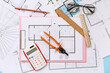 © Pixel-Shot - Architect's supplies with eyeglasses on house plans, top view