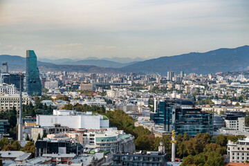 Wall Mural - View from the hill of mother Georgia on the city center of Tbilisi, Georgia with mountains in the background.