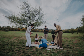 Poster - A diverse group of friends gathers in a park for a relaxing picnic. They enjoy food and drinks while surrounded by natural beauty and open skies.